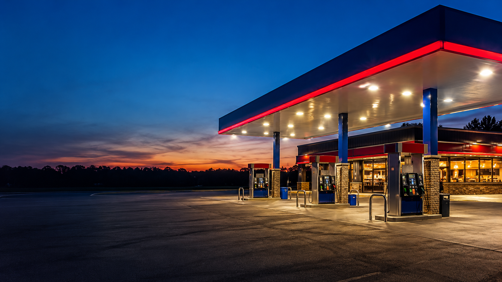 An inviting convenience store and fuel station illuminated at sunset